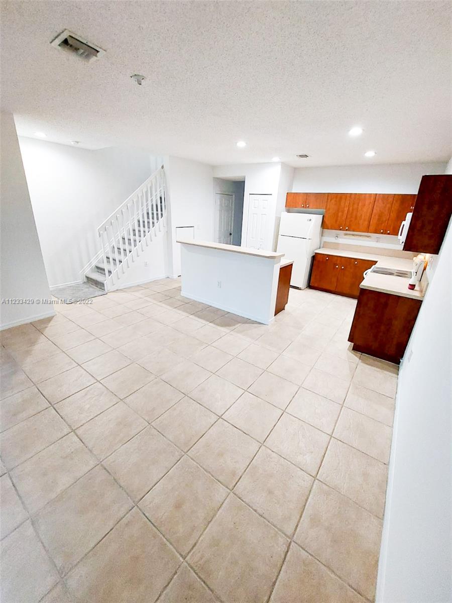 4282 Northeast 9th Street, Unit 4282 Homestead, FL 33033 - Photo 9 of 28 a view of an empty room with wooden floor
