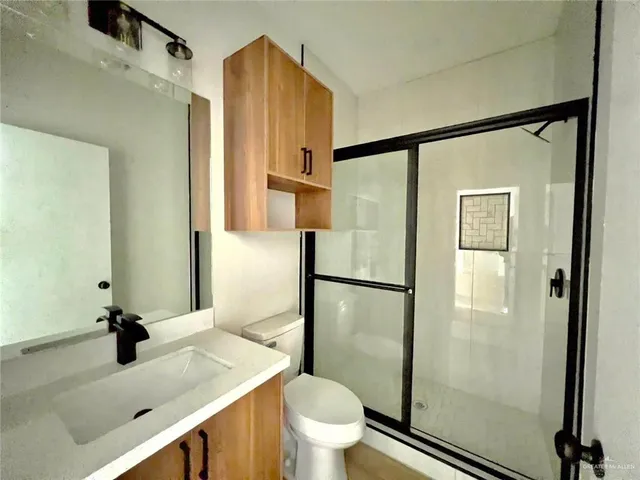 a bathroom with a sink toilet and shower