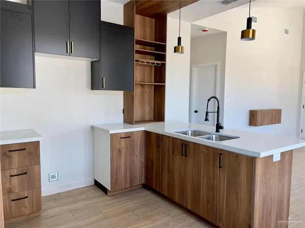 a kitchen with a sink and a refrigerator