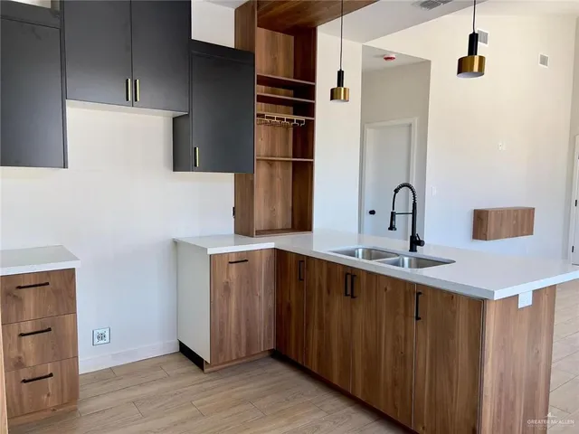 a kitchen with a sink and a refrigerator