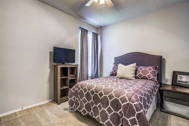 a large bed sitting in a bedroom next to a fireplace and a tv