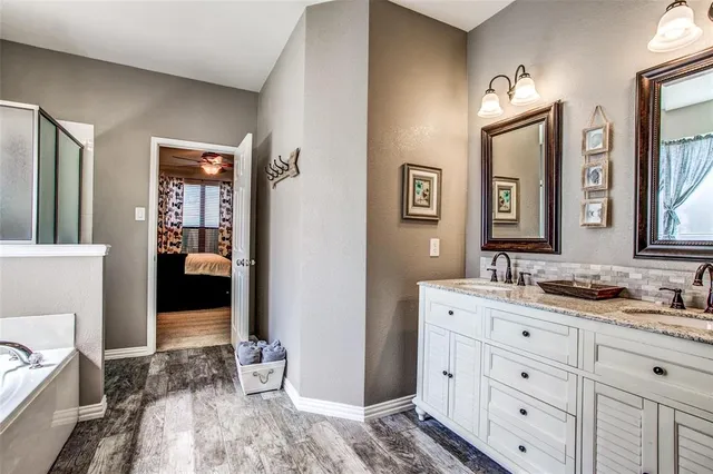 a en suite bathroom with double sink and a mirror