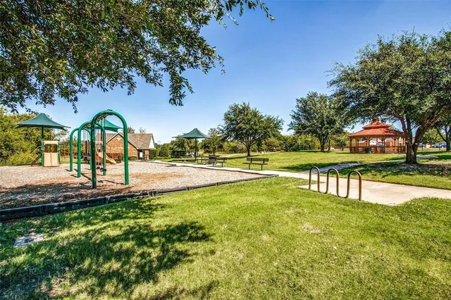 a view of swimming pool with outdoor seating and trees
