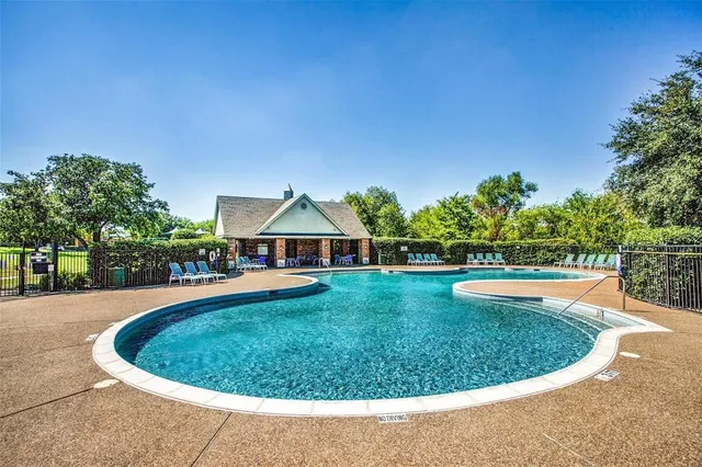 a view of a swimming pool and a yard
