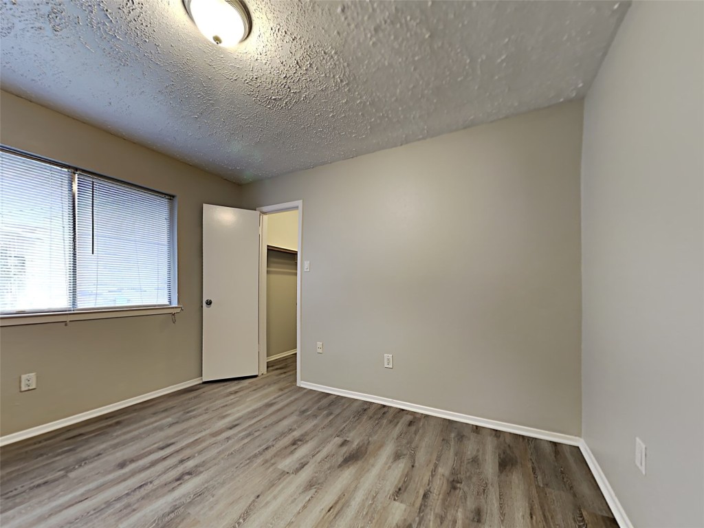 7306 Ridgeberry Drive Houston, TX 77095 - Photo 11 of 16 an empty room with wooden floor and windows