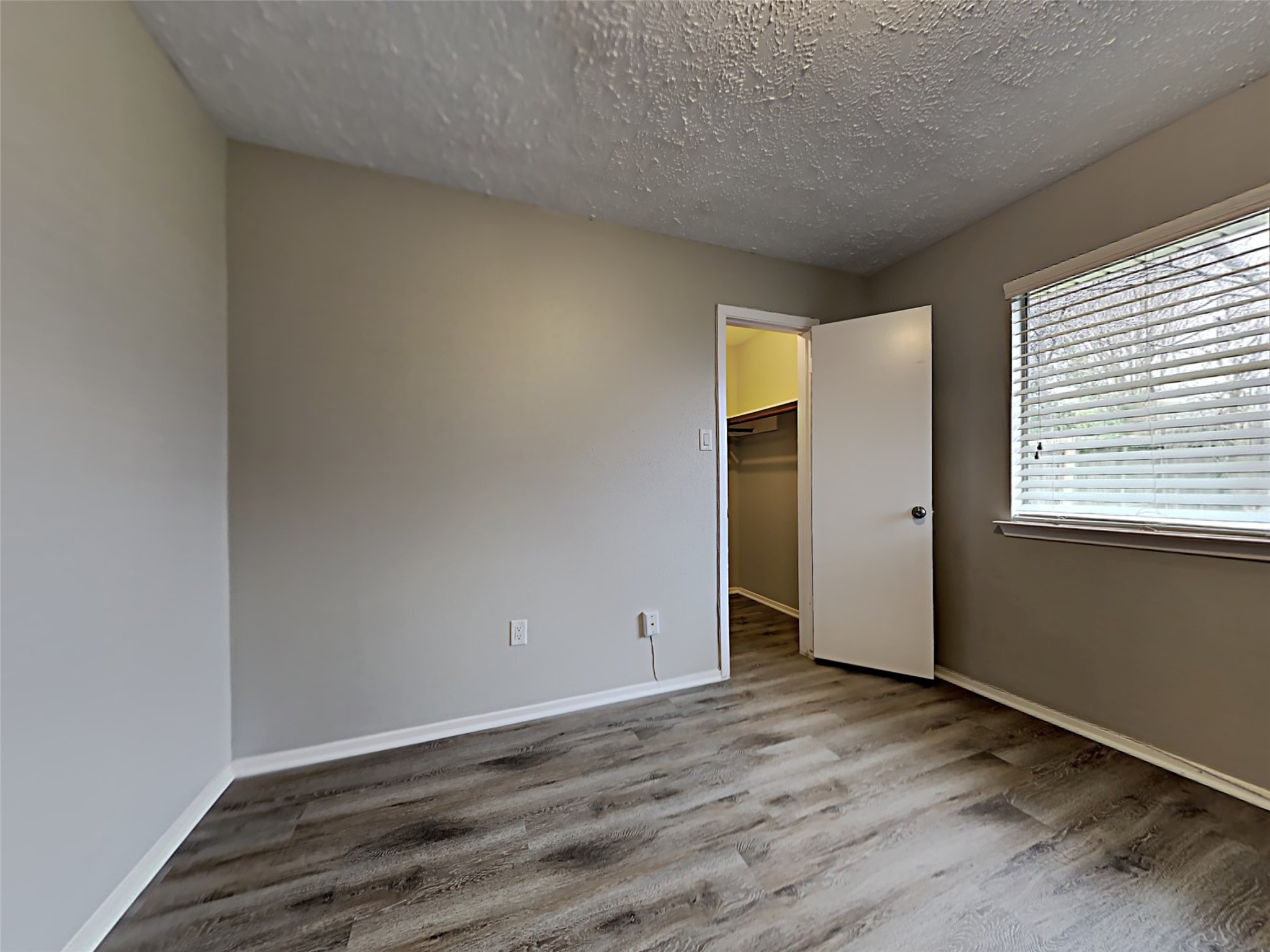 7306 Ridgeberry Drive Houston, TX 77095 - Photo 12 of 16 an empty room with wooden floor and windows