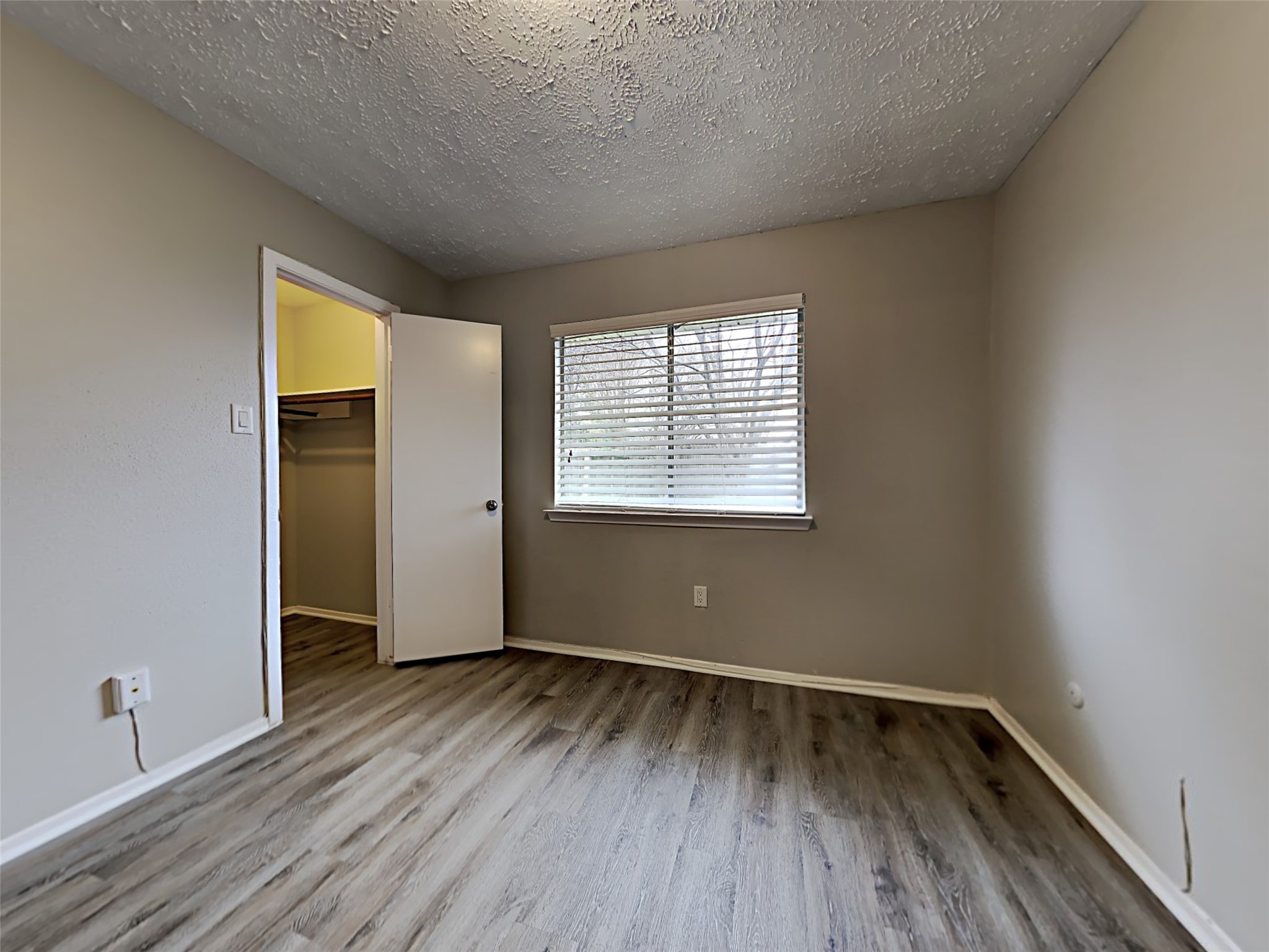 7306 Ridgeberry Drive Houston, TX 77095 - Photo 13 of 16 an empty room with wooden floor and windows