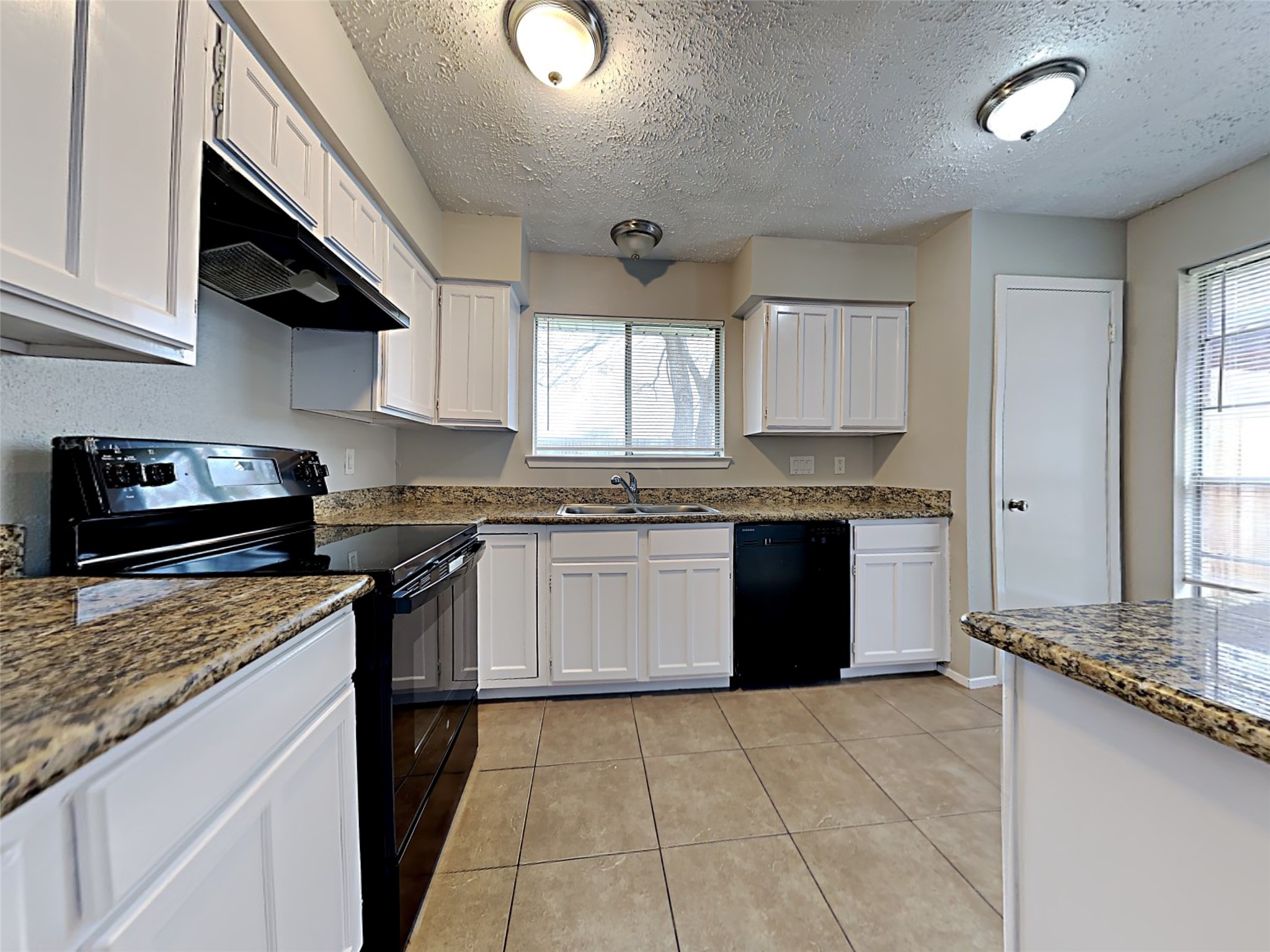 7306 Ridgeberry Drive Houston, TX 77095 - Photo 5 of 16 a kitchen with granite countertop a stove sink and cabinets