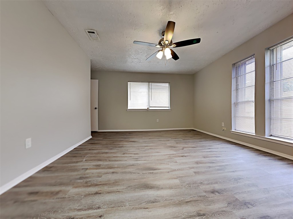 7306 Ridgeberry Drive Houston, TX 77095 - Photo 7 of 16 a view of empty room with wooden floor and fan