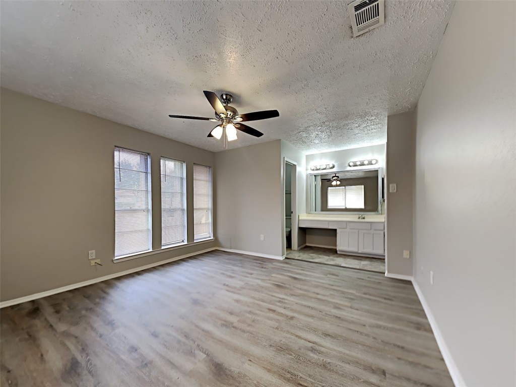 7306 Ridgeberry Drive Houston, TX 77095 - Photo 8 of 16 wooden floor in an empty room with a window