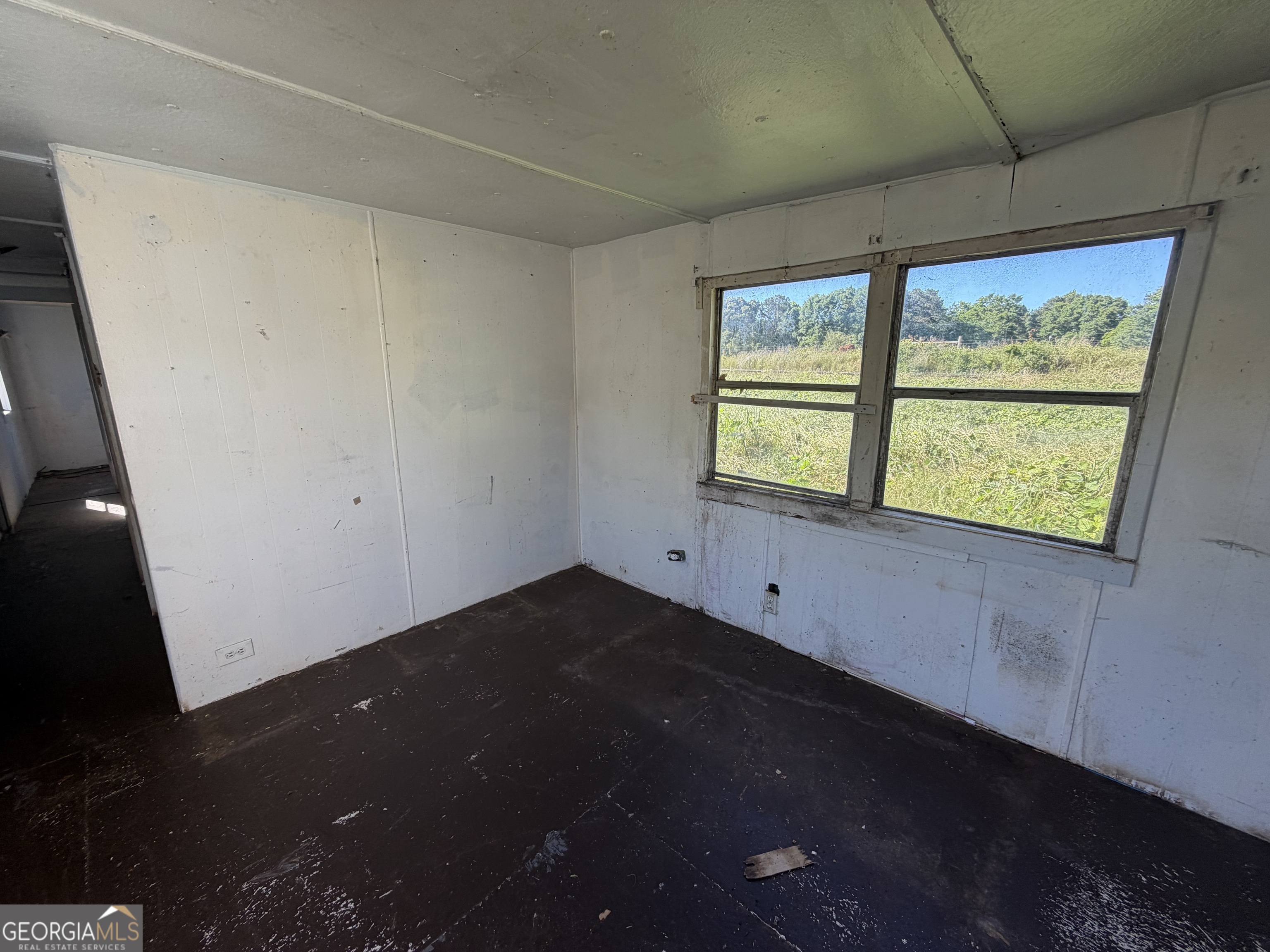 265 Aldora Street Barnesville, GA 30204 - Photo 4 of 9 a view of an empty room with a window