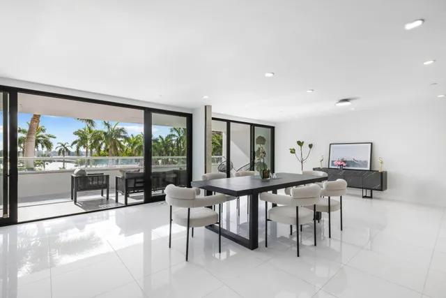 a view of a dining room with furniture large windows and wooden floor