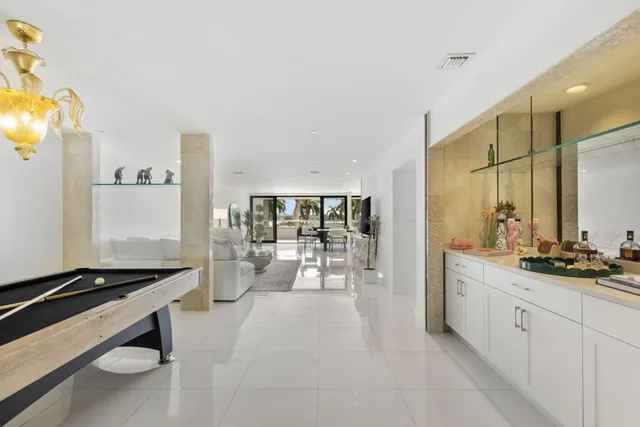 a large white kitchen with a large window and stainless steel appliances