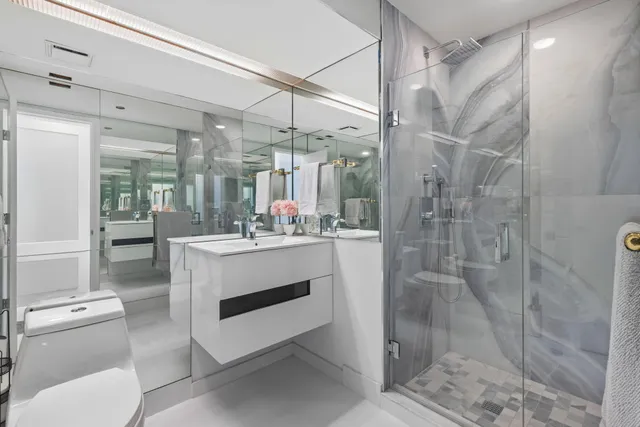 a bathroom with a sink shower and a mirror