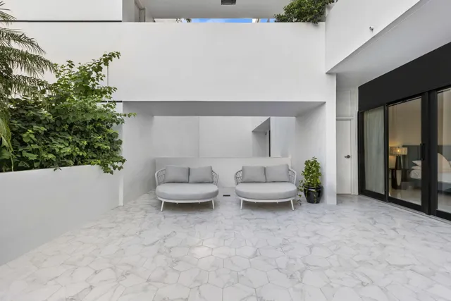 a living room with furniture and potted plant