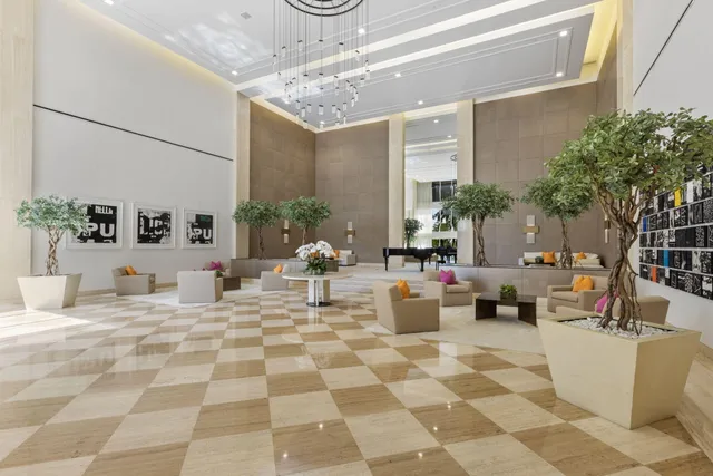 a living room with fireplace furniture and a chandelier