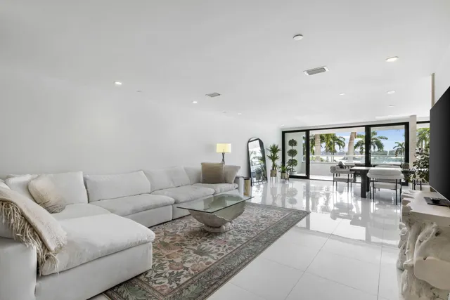 a living room with furniture and floor to ceiling window