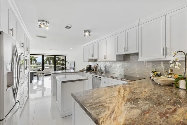 a kitchen with counter top space and living room