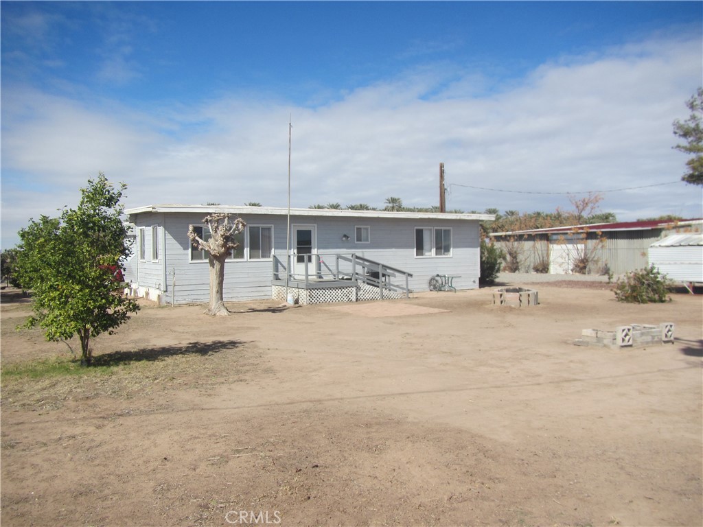 a swimming pool with outdoor seating and yard