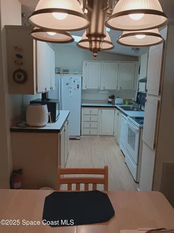 a kitchen with a sink cabinets and appliances