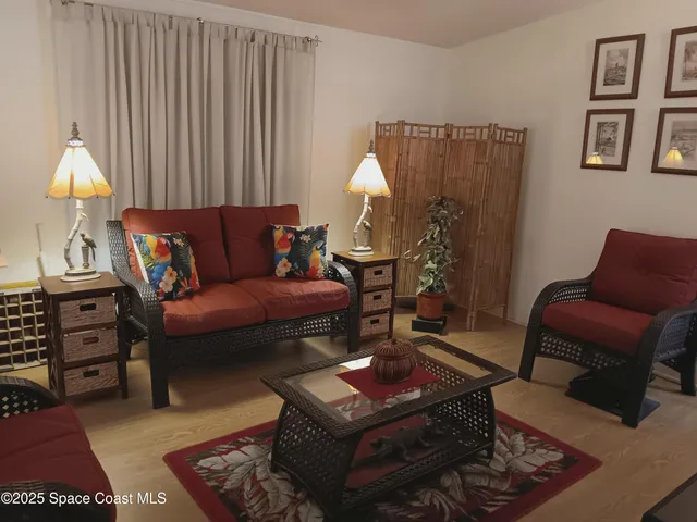 a living room with furniture a rug and a lamp