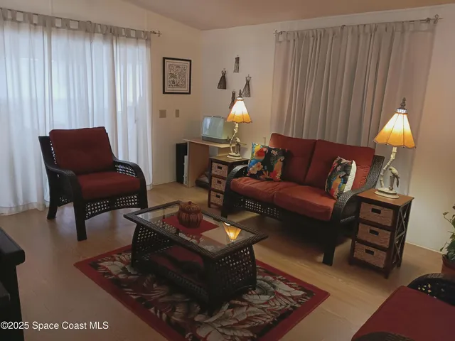 a living room with furniture a lamp and a window