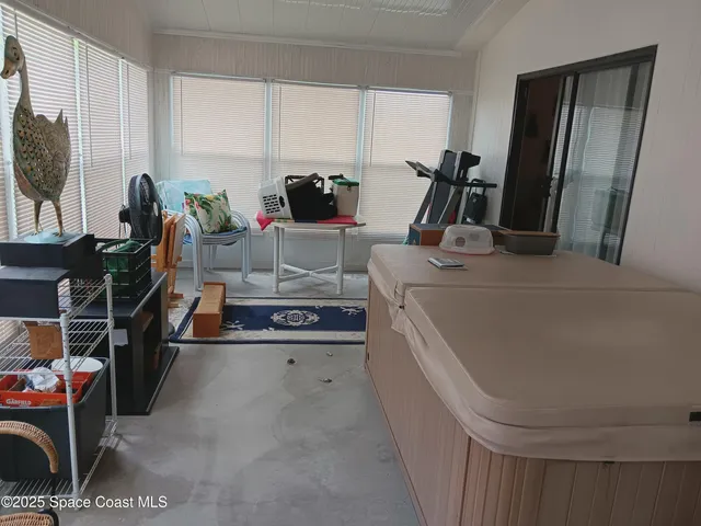 a room with furniture a flat screen tv and a window