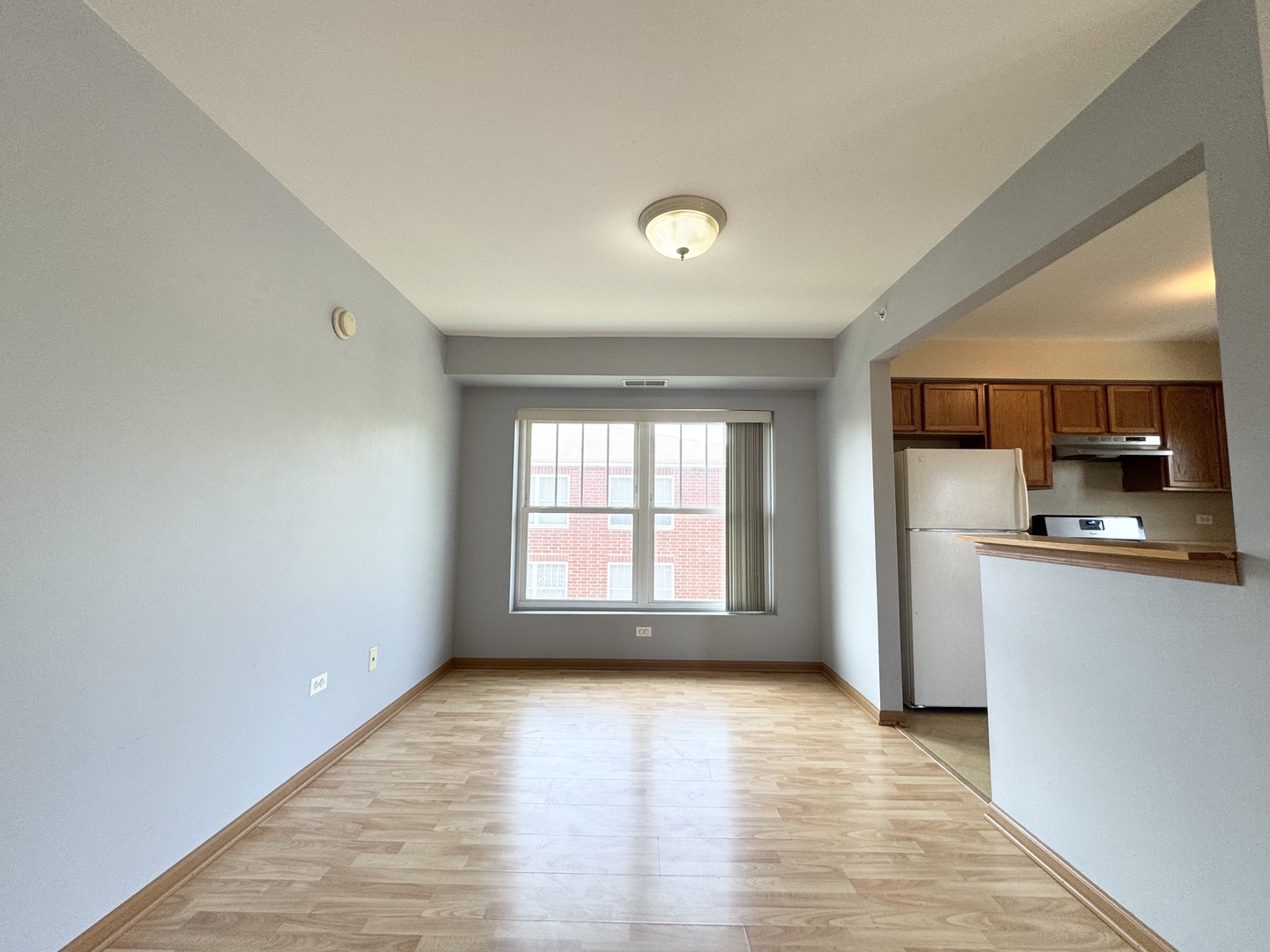 237 North Mill Road, Unit 14 Addison, IL 60101 - Photo 11 of 15 a view of empty room with kitchen and wooden floor