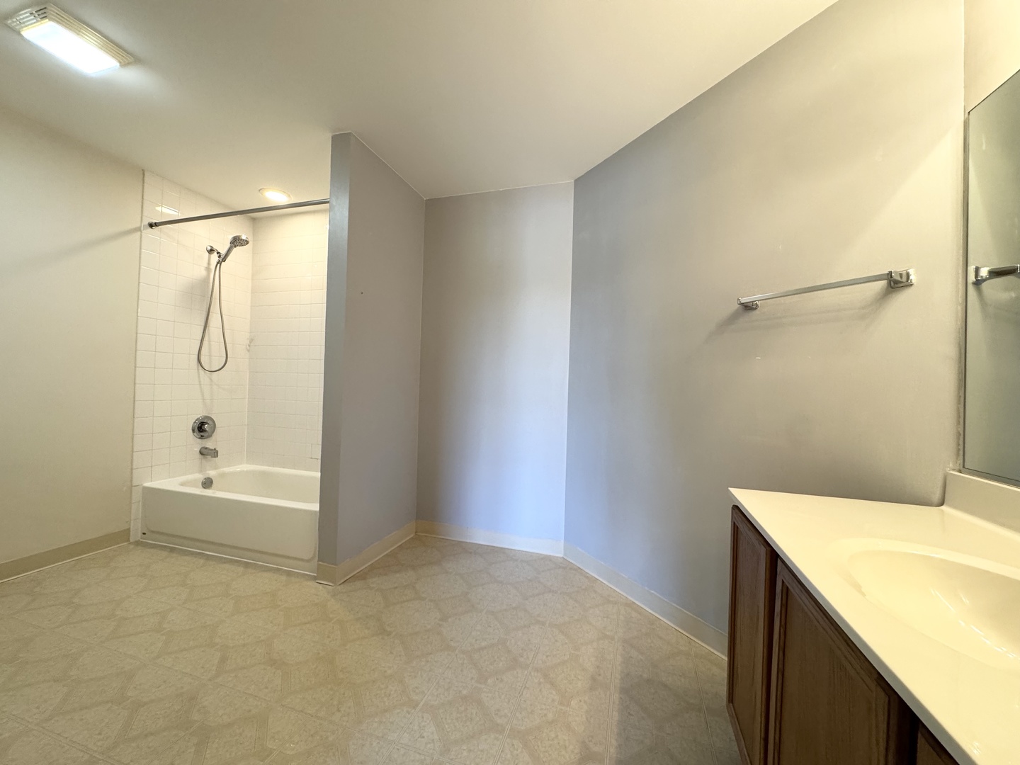 237 North Mill Road, Unit 14 Addison, IL 60101 - Photo 12 of 15 a bathroom with a granite countertop sink a mirror and a bathtub