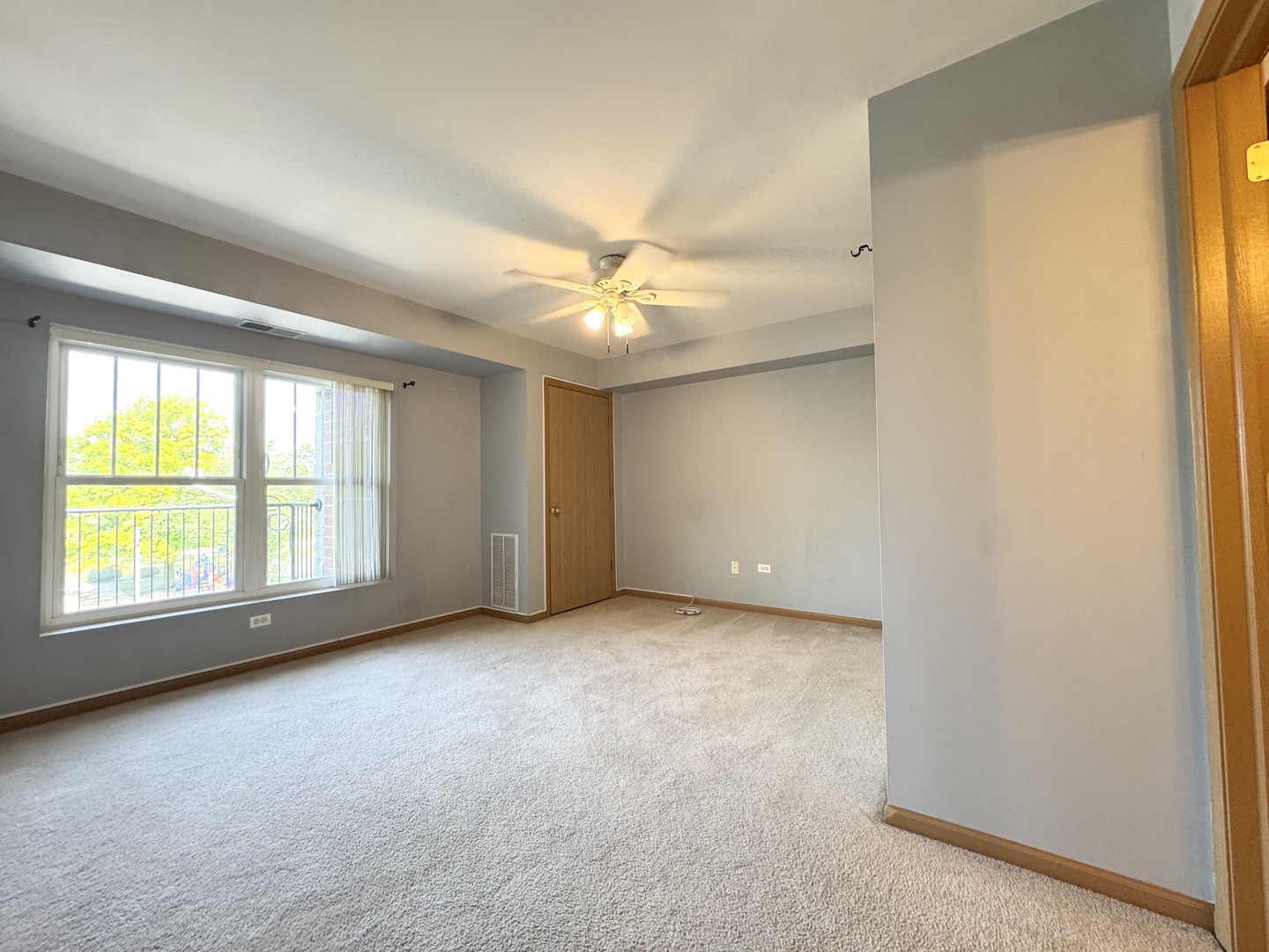 237 North Mill Road, Unit 14 Addison, IL 60101 - Photo 13 of 15 an empty room with a window and a ceiling fan