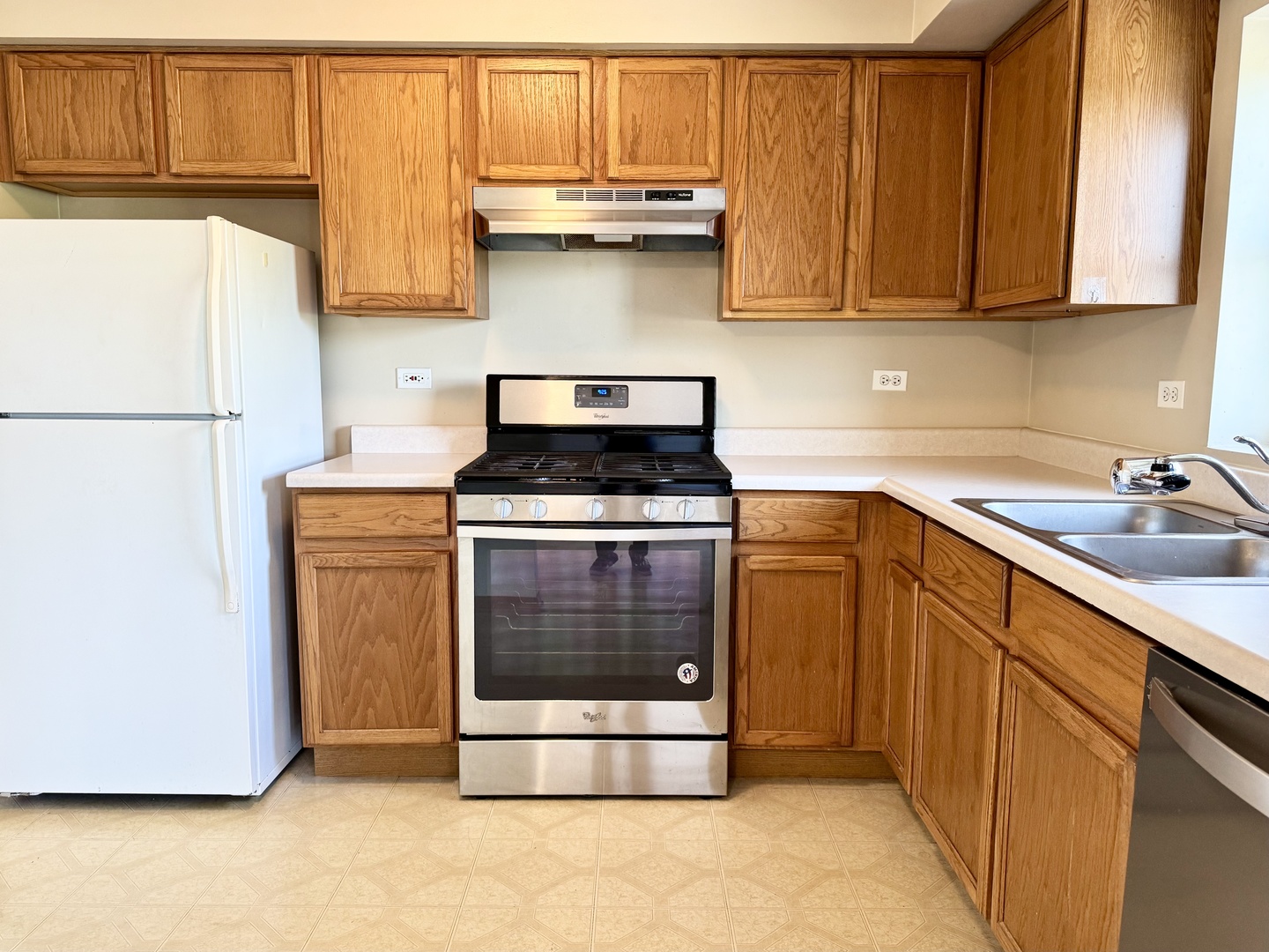 237 North Mill Road, Unit 14 Addison, IL 60101 - Photo 3 of 15 a kitchen with a sink and a refrigerator
