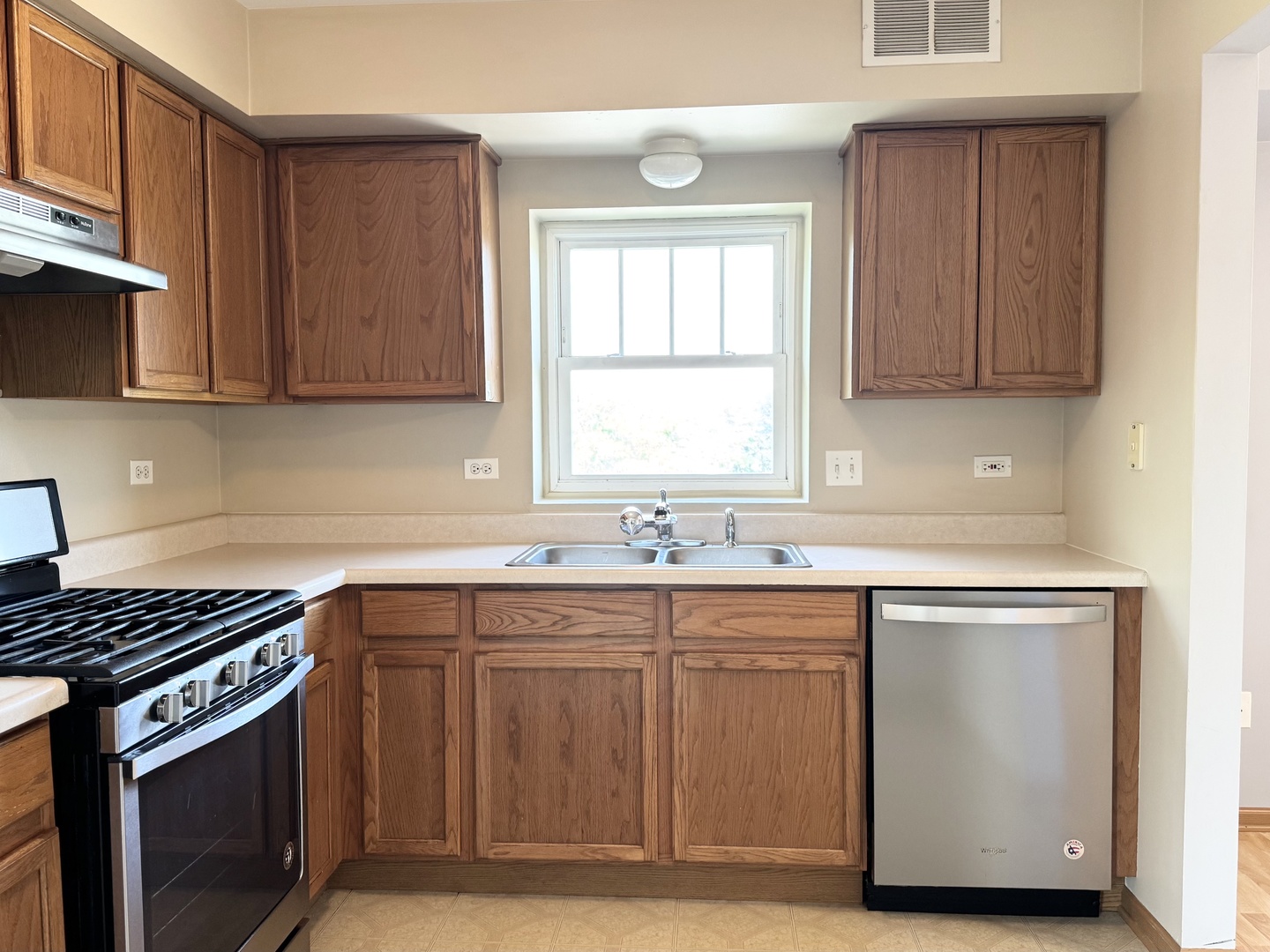 237 North Mill Road, Unit 14 Addison, IL 60101 - Photo 4 of 15 a kitchen with stainless steel appliances granite countertop a sink stove and cabinets