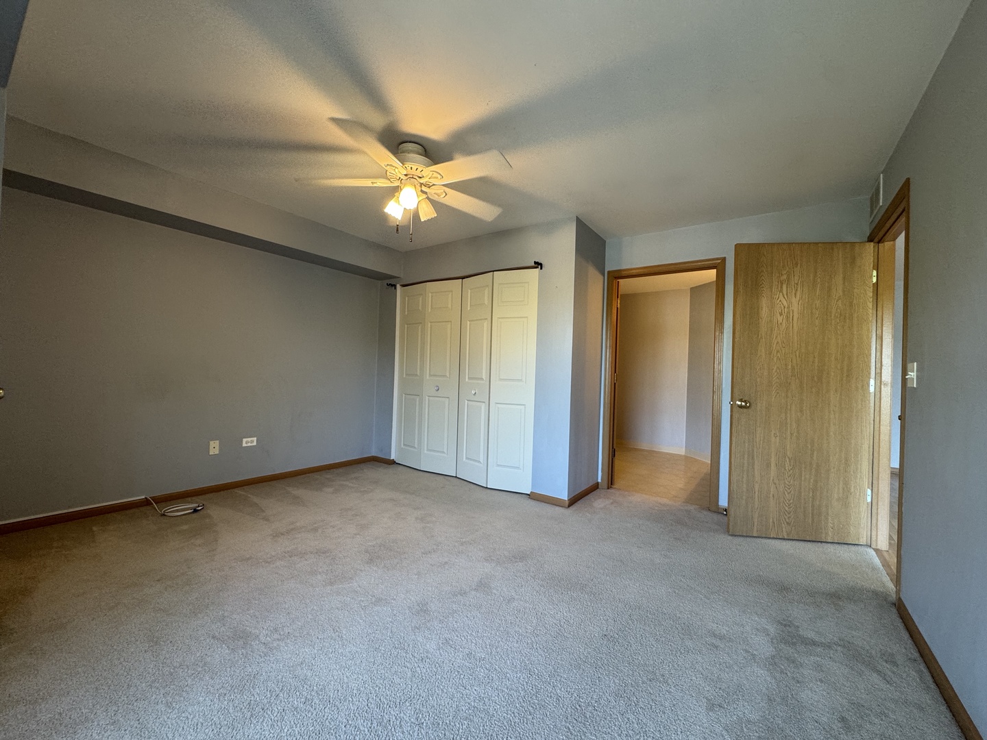 237 North Mill Road, Unit 14 Addison, IL 60101 - Photo 5 of 15 an empty room with a ceiling fan and a window