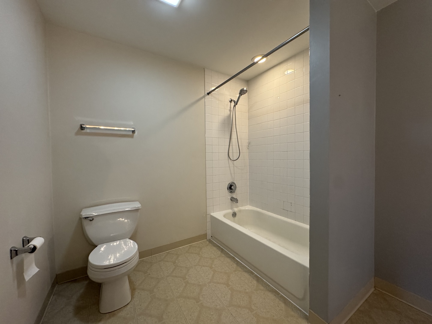 237 North Mill Road, Unit 14 Addison, IL 60101 - Photo 6 of 15 a bathroom with a granite countertop toilet a sink and a bathtub