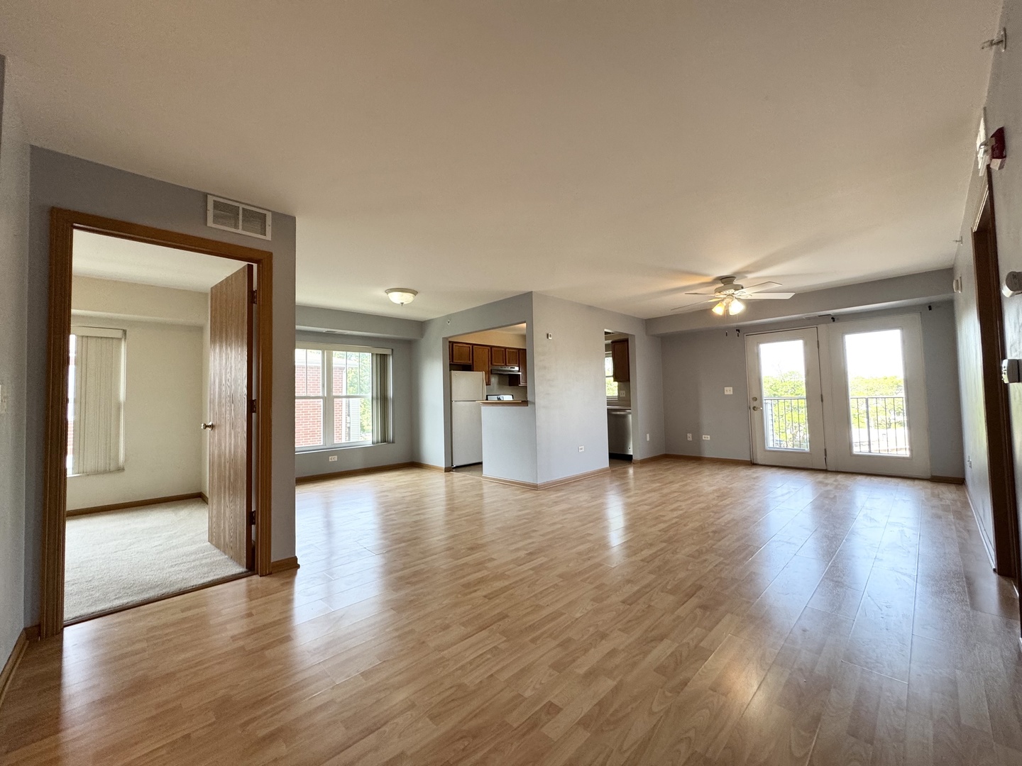 237 North Mill Road, Unit 14 Addison, IL 60101 - Photo 9 of 15 a view of a big room with wooden floor and a kitchen