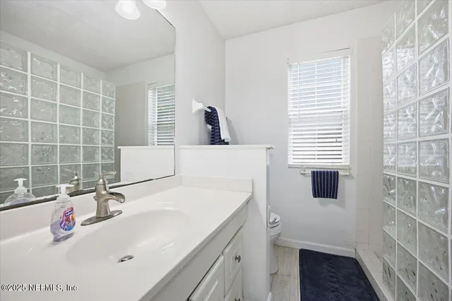 a bathroom with a sink and a large mirror
