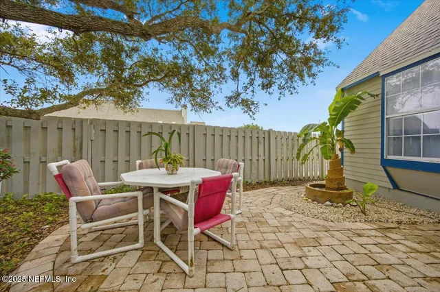 a view of a patio with a table and chairs
