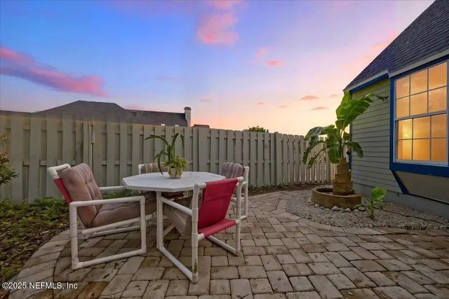 a view of a chairs and tables in the backyard