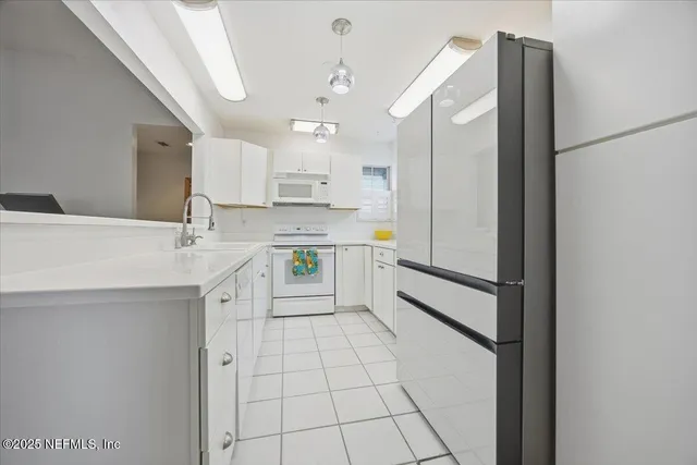 a kitchen with stainless steel appliances a refrigerator sink and cabinets