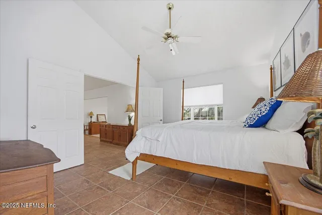 a bed room with a bed and a chair