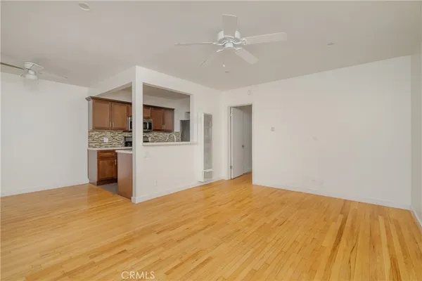 a kitchen with granite countertop a stove a sink and a microwave