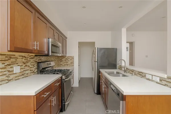 a kitchen with stainless steel appliances granite countertop a stove and a microwave