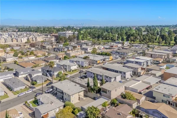 an aerial view of a city with lots of residential buildings and ocean view
