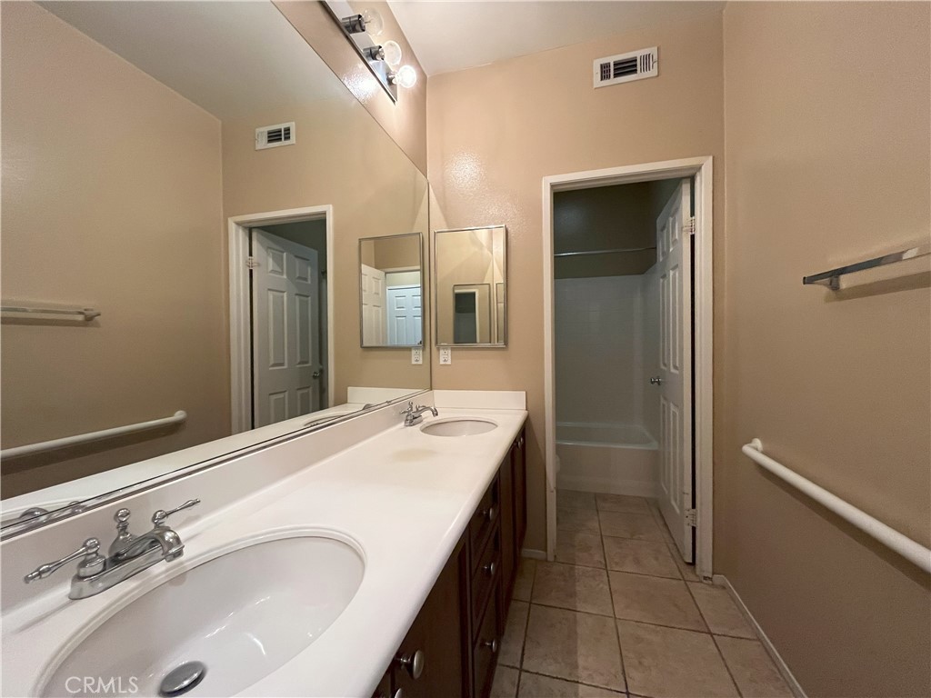 12758 Royal Palm Lane Riverside, CA 92503 - Photo 12 of 16 a bathroom with a sink and a mirror