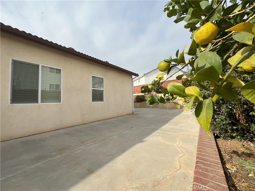 12758 Royal Palm Lane Riverside, CA 92503 - Photo 15 of 16 a house with a yard and flowers