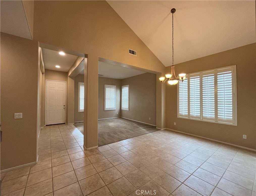 12758 Royal Palm Lane Riverside, CA 92503 - Photo 4 of 16 a view of an empty room with window and chandelier