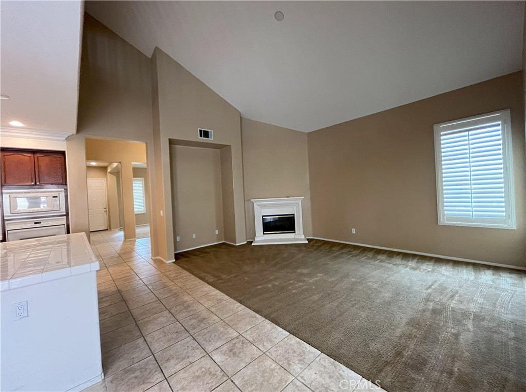 12758 Royal Palm Lane Riverside, CA 92503 - Photo 5 of 16 a view of a hallway with a kitchen
