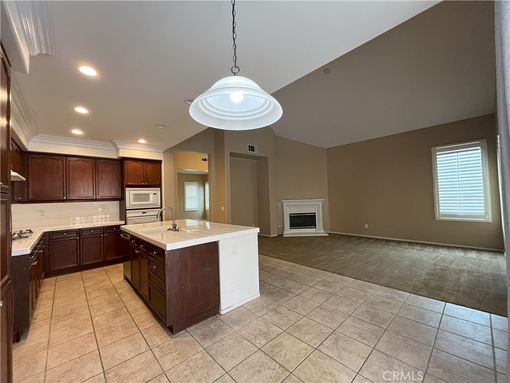 12758 Royal Palm Lane Riverside, CA 92503 - Photo 6 of 16 a kitchen with a stove a refrigerator and a sink