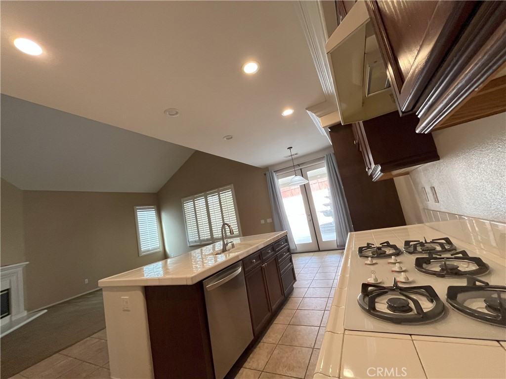 12758 Royal Palm Lane Riverside, CA 92503 - Photo 7 of 16 a kitchen with a sink a stove and wooden floor