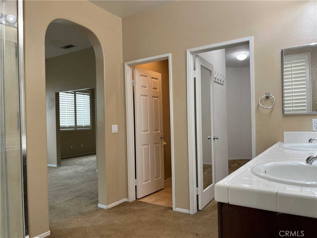 12758 Royal Palm Lane Riverside, CA 92503 - Photo 9 of 16 a view of a bathroom from a hallway